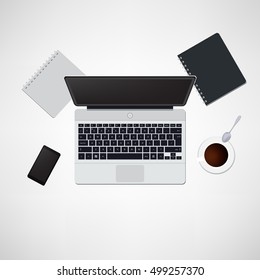 Office desk with laptop, notepad, tablet, smartphone and coffee cup top view background