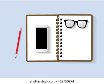 Office desk with notepad, smartphone top view 