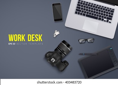 Office desk table with laptop, photo camera, glasses, graphic tablet, pen, phone and flash drive. Top view with copy space. Eps10 vector template.