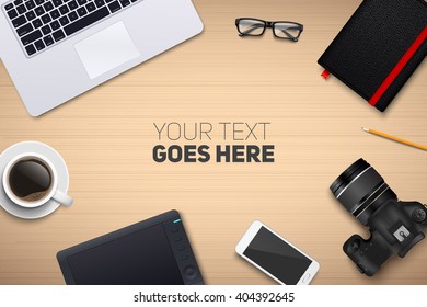 Office desk table with laptop, photo camera, glasses, graphic tablet, pencil, notebook, phone and coffee cup. Top view with place for your text. Eps10 vector template.