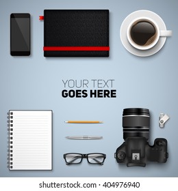 Office desk table with photo camera, glasses, graphic tablet, pencil, pen, notebooks, flash drive, phone and coffee cup. Top view with copy space. Eps10 vector template.