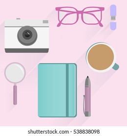 Office desk table with photo camera, glasses, flash drive, pen, notebooks, magnifying glass, and coffee cup flat design. Top view pink background. Eps10 vector template.