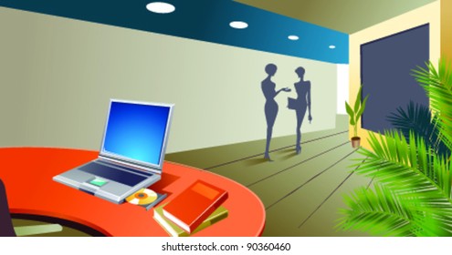 Interior de oficina con portátil abierto en el escritorio