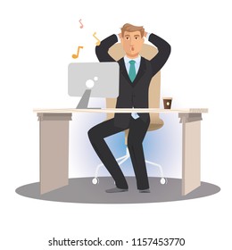 Office man sitting at the table and relaxes, listening to music