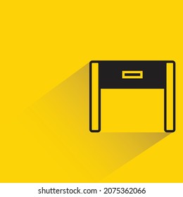 office table with shadown on yellow background