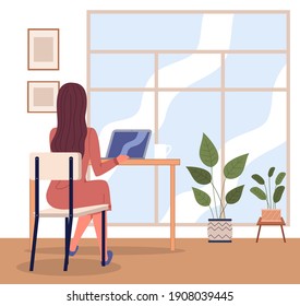 Office woman at a desk with a laptop back view. Business woman or a clerk working at her office table near big window. Freelancer at home office. Manager, enterpreneur performs work on a computer