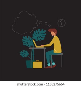 office worker. a man sitting at a table and working on a laptop