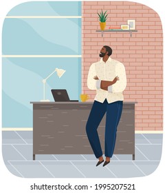 Office worker standing next to table with laptop. Businessman or clerk working at his office workplace. Smiling man enterpreneur resting during break in working day, thinking about something