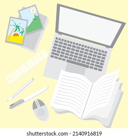 office worker's desk with laptop and stationery