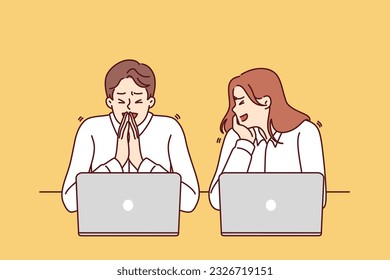 Office workers laugh sitting at workplace with laptops for concept of friendly team in business. Guy and girl laugh taking break from work and being distracted from performance of official tasks