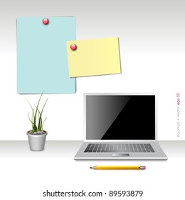 office workplace with notebook and memo on wall
