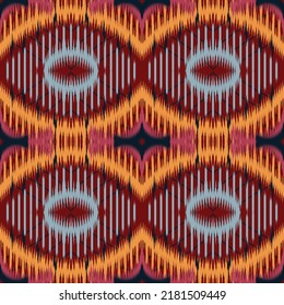 Ogee Seamless geometric pattern, based on ikat fabric style Vector illustration Yellow  blue ogee shapes on red background