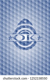 OK  blue badge with geometric background.