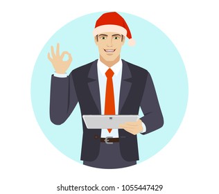 OK! Businessman in Santa hat showing a okay hand sign and holding digital tablet PC. Portrait of businessman in a flat style. Vector illustration.