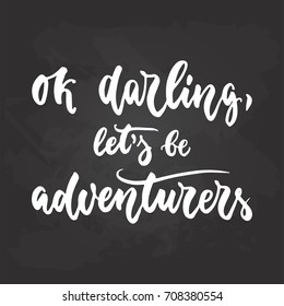 Ok darling, let's be adventurers - travel hand drawn lettering quote in white color on the black chalkboard background. Fun ink calligraphy inscription