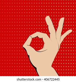 Ok hand on red spotted background.