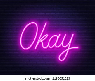 Okay neon sign on brick wall background.