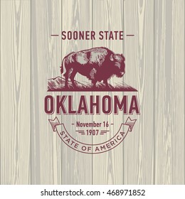 Oklahoma, Sooner State, stylized emblem of the state of America, Buffalo, bison, on wooden background