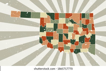 Oklahoma vintage map. Grunge poster with map of the us state in retro color palette. Shape of Oklahoma with sunburst rays background. Vector illustration.