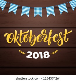 Oktoberfest 2018. Trendy Oktoberfest lettering on wooden background.