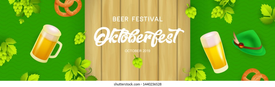 Oktoberfest banner design with beer glasses, pretzels and hops on wooden and green textured background. Lettering can be used for invitations, signs, announcements