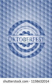 Oktoberfest blue emblem or badge with geometric pattern background.