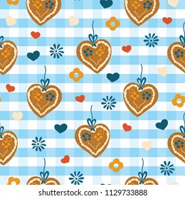 Oktoberfest Lebkuchenherz Gingerbread heart seamless vector pattern on a blue and white checkered background with blue, red, and white hearts and flowers. Great for backgrounds, fabric, and packaging.