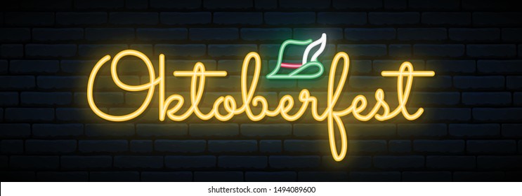 Oktoberfest neon signboard. Light bright lettering on brick wall background.