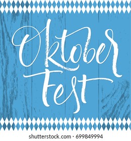 Oktoberfest white lettering on blue board texture. Handwritten modern calligraphy, brush painted letters. Vector illustration. Template for banners, posters, merchandising, cards or photo overlays.