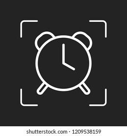 old alarm clock, simple icon, linear symbol with thin outline. White object in camera autofocus on dark background