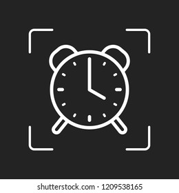 old alarm clock, simple icon, linear symbol with thin outline. White object in camera autofocus on dark background