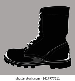Old black boots on a gray background