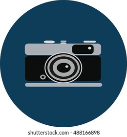 Old black and grey camera on blue circle