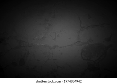 Old black wall in spots, cracks, stains. Grey painted concrete wall in abstract grunge style. Grunge loft background texture for backgrounds, portraits, posters.