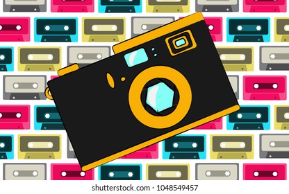 Old black and yellow retro vintage antique hipster obsolete camera on the background of a pattern of multi-colored audio cassettes. Vector illustration.