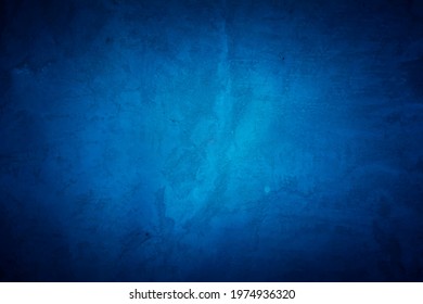 Old blue wall in spots, cracks, stains. Painted concrete wall in abstract grunge style. Grunge loft background texture for backgrounds, portraits, posters.