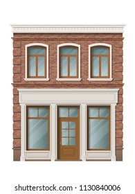 Old brick building facade with windows and shop on ground floor. Traditional classic architecture of front building. Storefront with large windows on the ground floor.