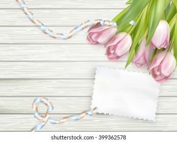 Old card and fresh tulips is lying on wooden background. EPS 10 vector file included