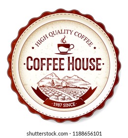 An old coffee label in warm colors against a light background. The stamp of the product quality mark.