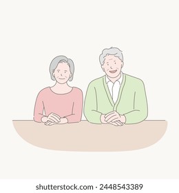 an old couple sitting at a table talking, a couple on good terms