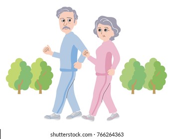 An old couple walks in a park