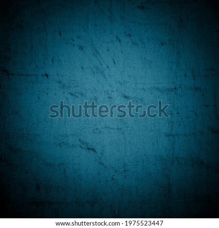 Old dark blue wall in spots, cracks, stains. Painted concrete wall in abstract grunge style. Grunge loft background texture for backgrounds, portraits, posters.