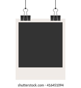 old empty photo with binder clips hanging at black twine