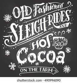 Old fashioned sleigh rides and hot cocoa on the farm. Chalkboard hand-lettering sign. Hand drawn typography with a mug of hot cocoa. Signpost on blackboard background with chalk