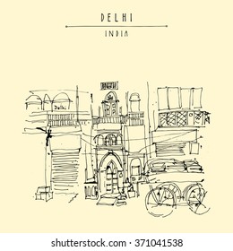 Old historic building and a cart in Main Bazar, Paharganj, Delhi, India. Hand drawn cityscape sketch. Travel art. Vintage artistic postcard template. Vector illustration
