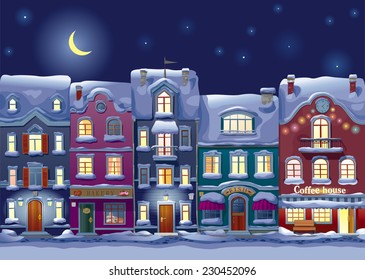 Old historical houses, shops and cafe at the snow-covered city street at midnight