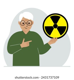 A old man holds a sign with a warning about nuclear danger. The concept of nuclear war, radiation, biohazard.