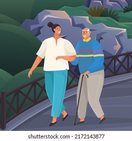 Old man leans on stick and walks with woman in park. Sanatorium or comfortable nursing home. Girl take care of man from nursing home. People stroll against background of green trees in garden