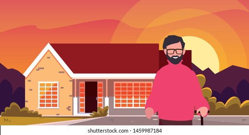 old man standing next house exterior