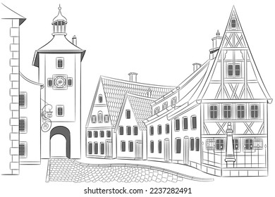 Old medieval street with houses and a tower in Rothenburg ob der Tauber.